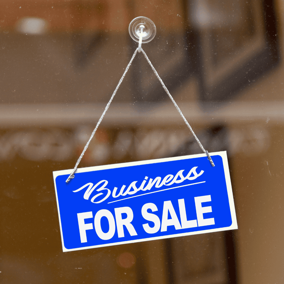 An external audit can make a business more attractive to prospective buyers - image depicts a business for sale sign in the window of a cafe. 