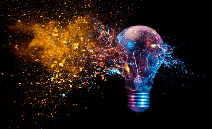 Grants for business - Consilium Chartered Accountants provide grants advisory support to Scottish businesses seeking grant funding. Image depicts a lightbulb exploding in a mix of blue, purple, pink and gold colours against a black background.